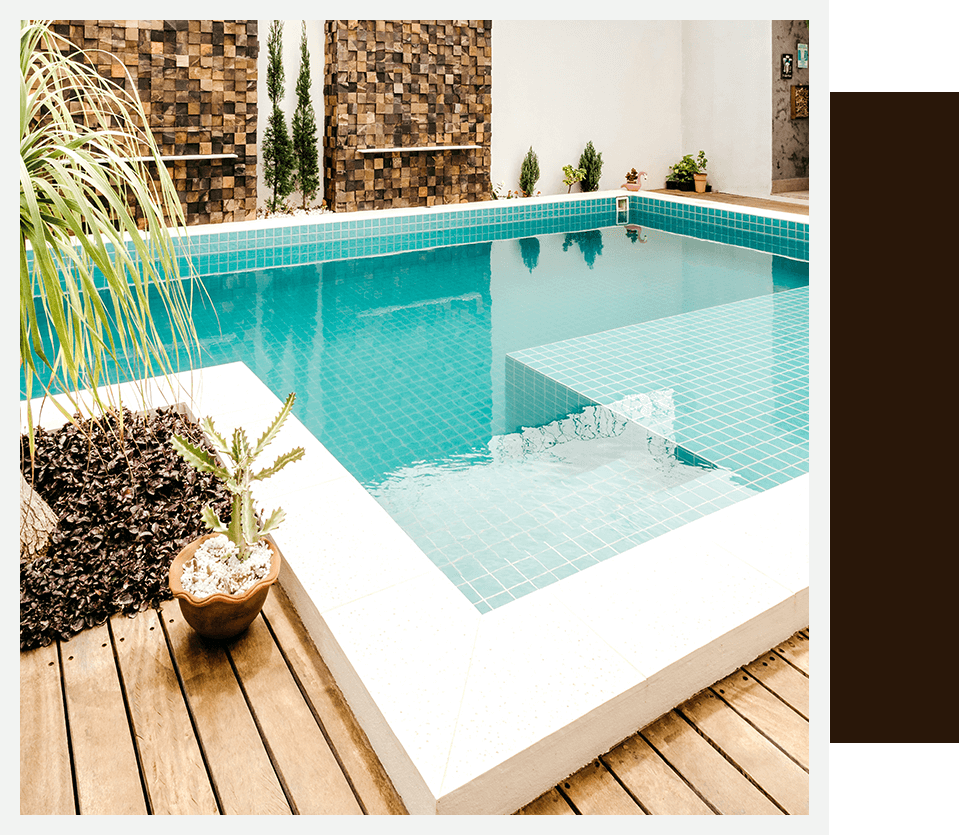 blue swimming pool near green trees during daytime